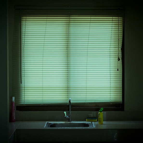 A front on centred photo of a kitchen window and sink.