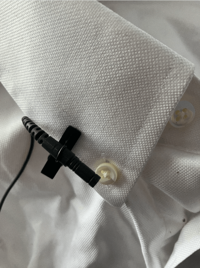 lapel mic on white collar of shirt